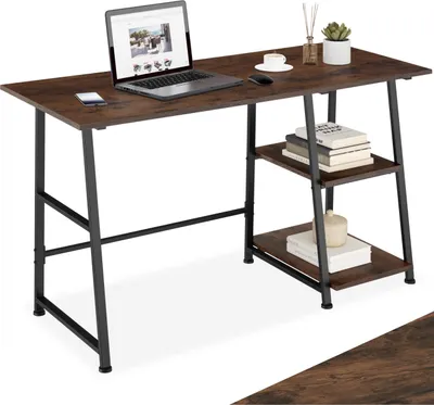 A desk with a laptop, phone, and books on it.
