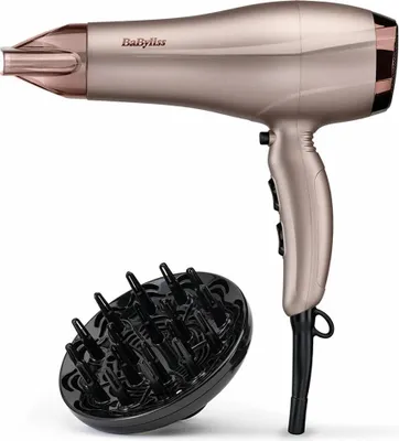 A rose gold Babyliss hair dryer and a black diffuser attachment are shown against a white background.