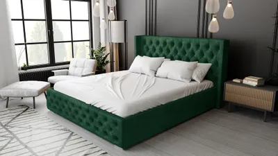 A bedroom scene with a green upholstered bed as the main focus, set against a dark gray wall and large windows.