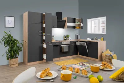 A modern kitchen setup with cabinets, appliances, and a dining table with food.
