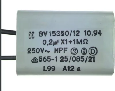 A close-up studio shot of a capacitor with text and symbols printed on its casing.
