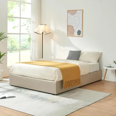 A bedroom scene with a bed, lamp, and artwork.