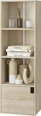 A tall, narrow bookshelf with four shelves and one drawer, displaying decorative items and books.