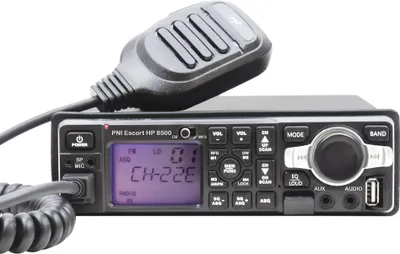 A close-up studio shot of a CB radio with a microphone attached, against a white background.