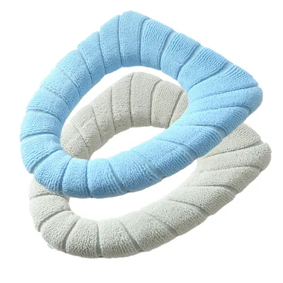 Two toilet seat covers, one light blue and one light gray, are arranged in a crisscross pattern against a white background.
