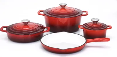 A set of red cast iron cookware, including pots and a frying pan, arranged on a white background.