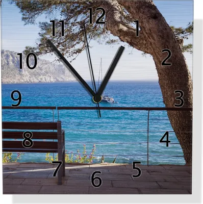 Produktbild von Wallario Design Wanduhr Einsame Bank am Meer - Spanien im Sommer aus Aluverbund, Größe 30 x 30 cm