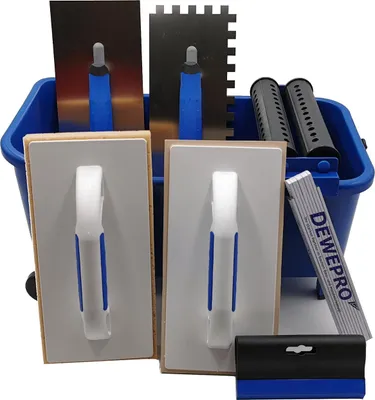 A set of tile laying tools in a blue bucket.