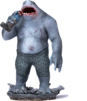 A statue of King Shark from The Suicide Squad, holding a severed limb.