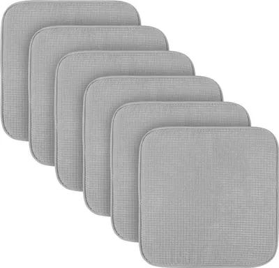 A stack of six grey square seat cushions, arranged in a staggered diagonal pattern.