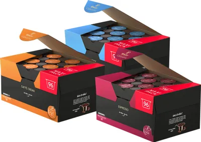 Three open boxes of coffee capsules, each with a different color theme and coffee type.