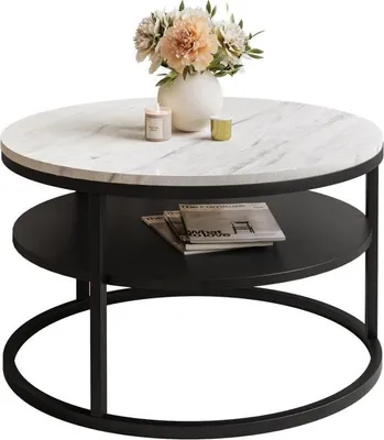 A round coffee table with a marble top and a black metal frame, featuring a shelf below and decorative items on top.
