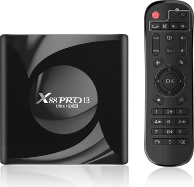 A black media box and its remote control are displayed side-by-side on a white background.