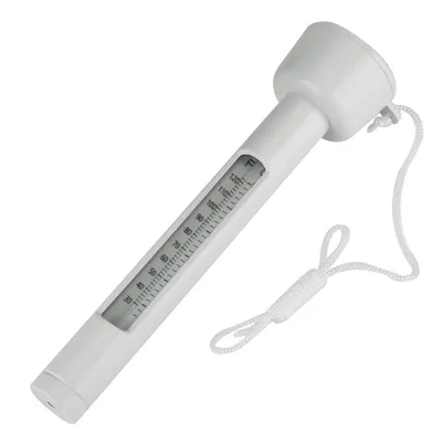 A white floating thermometer with a string attached lies on a white background.