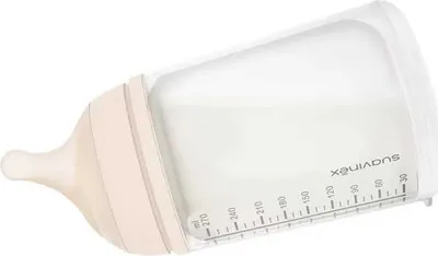 A baby bottle filled with milk, tilted on a white background.