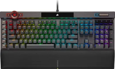 A top-down view of a CORSAIR K100 RGB gaming keyboard with its RGB lighting illuminated.