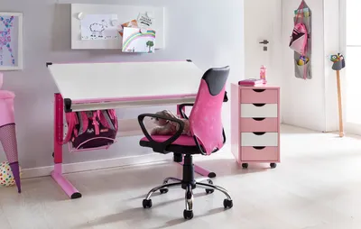 A child's desk and chair setup in a room.