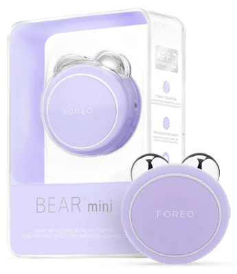 A product shot of a FOREO BEAR mini smart microcurrent facial toning device in its packaging, with a second device shown outside the packaging.