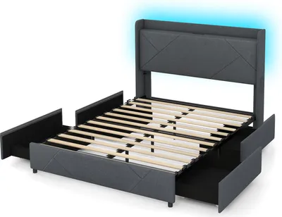 A grey upholstered bed frame with a headboard featuring integrated LED lighting, shown with drawers pulled out.
