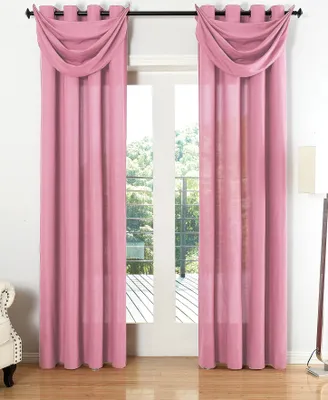 Two pink curtains with a decorative valance are hung over a doorway leading to an outdoor patio.