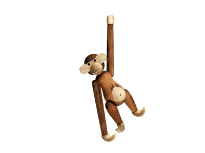 A wooden monkey toy hanging from an invisible support.