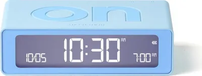 A light blue digital alarm clock with a digital display showing the time.