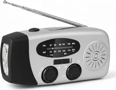 A silver and black emergency radio with a flashlight and antenna, shown against a white background.
