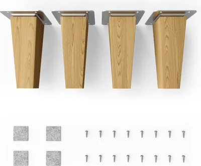 Four wooden furniture legs with metal mounting plates, along with felt pads and screws, are displayed against a white background.