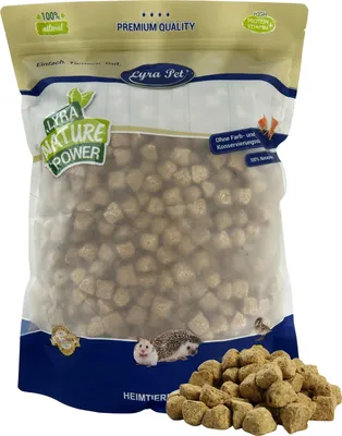 A bag of pet food with some food spilled in front.