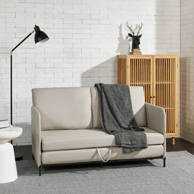 A modern living room scene with a sofa, lamp, and cabinet.