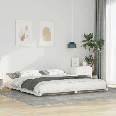 A bedroom scene with a bed frame and bedding.