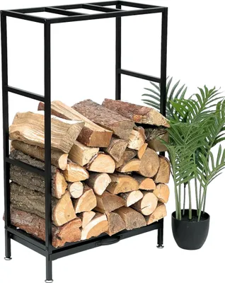 A black metal firewood rack filled with logs, next to a potted plant.