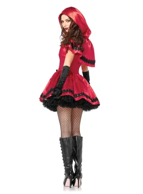 A woman wearing a red hooded costume with black trim and black gloves, fishnet stockings, and black boots, posing against a white background.