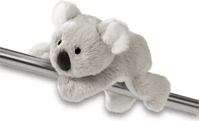 A plush koala toy is clinging to a metal bar.