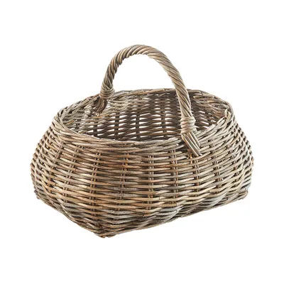 A woven rattan basket with a handle, isolated on a white background.