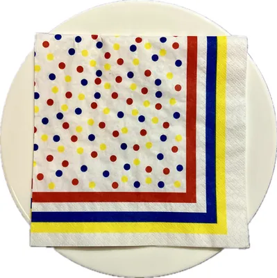 A polka dot napkin on a white plate.