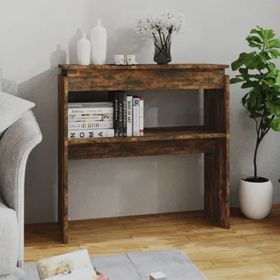 A console table with books and decorative items in a living room setting.