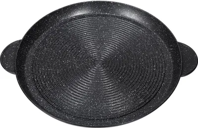 A top-down view of a round, black grill pan with a speckled pattern and concentric ridges.