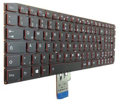 A close-up, angled view of a black keyboard with red accents and a ribbon cable attached.