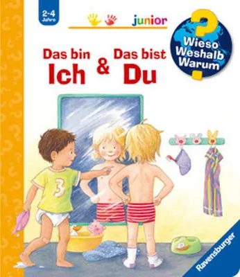Two young children in a bathroom, one looking in a mirror.