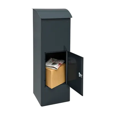A dark gray parcel mailbox with its lower door open, revealing a cardboard box and a newspaper inside.