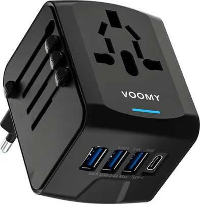 A black universal travel adapter with multiple USB ports and a universal socket on top.