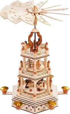A multi-tiered wooden Christmas pyramid with decorative cutouts and small figures.