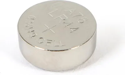 A close-up studio shot of a single silver button cell battery against a white background.