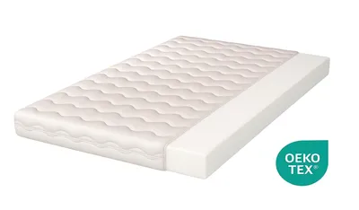 A white mattress is shown on a white background, with a portion of the mattress cut away to reveal its internal structure. A green and white OEKO-TEX logo is present in the bottom right corner.