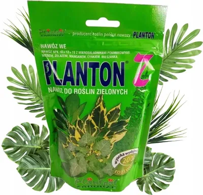 A bag of fertilizer for green plants, surrounded by artificial leaves.