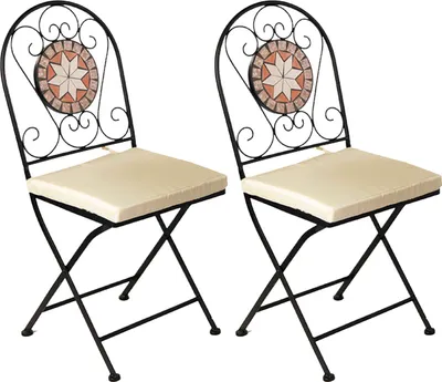 Two black metal folding chairs with beige cushions and decorative mosaic tile backs.