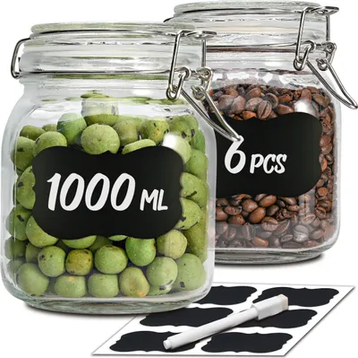 Two glass jars with clamp lids, one filled with green spherical items and labeled '1000 ML', the other filled with coffee beans and labeled '6 PCS'. A sheet of black labels and a white marker are in the foreground.