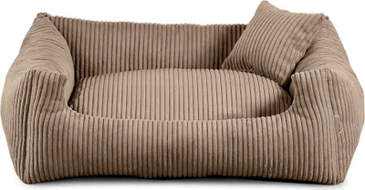 A close-up, front-facing view of a light brown, corduroy dog bed with a small pillow.