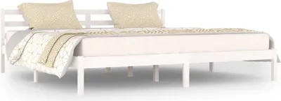 A white wooden bed frame with two pillows and a blanket on a white background.